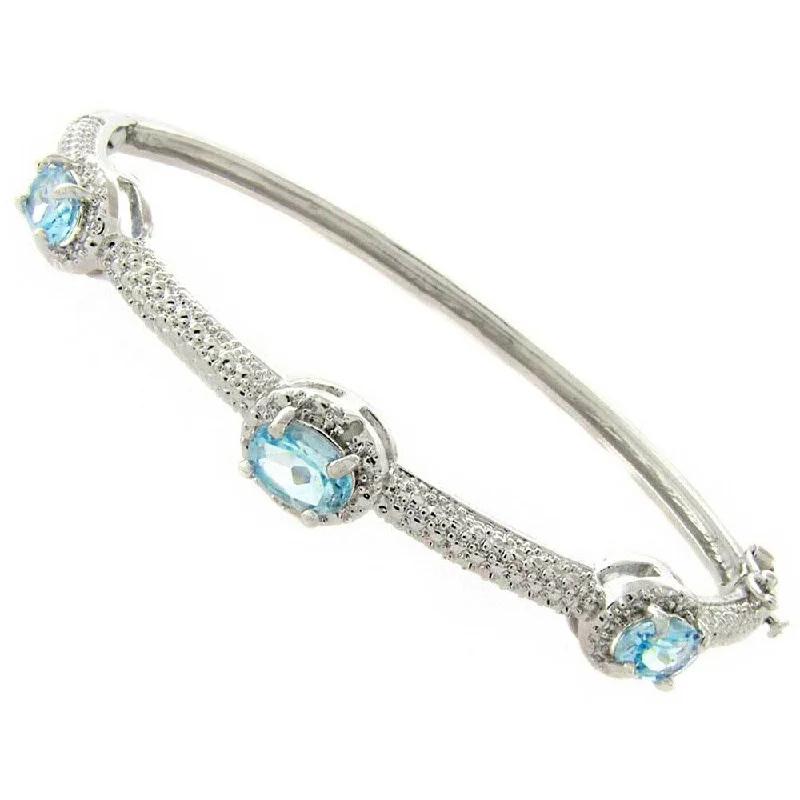 Furrowed design bracelet-Dolce Giavonna Silverplated Blue Topaz and Diamond Accent Bangle Bracelet